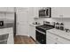 Close up on stainless steel appliances, white subway tile backsplash, and white cabinetry in the kitchen at 4944 Jatoba Rd, Acworth, GA 30101