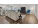 Open-concept living room featuring a sectional sofa, hardwood floors, and modern decor at 4944 Jatoba Rd, Acworth, GA 30101