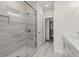 Elegant bathroom featuring tiled walk-in shower, modern vanity, and stylish gray flooring at 656 Soul Aly # 101, Alpharetta, GA 30009