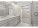 Bright bathroom with double vanity, sleek fixtures, and glass-enclosed shower for a spa-like experience at 656 Soul Aly # 101, Alpharetta, GA 30009