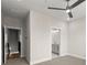 Bedroom featuring neutral walls and carpet, with doorways leading to a bathroom and hallway at 656 Soul Aly # 101, Alpharetta, GA 30009
