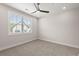 Neutral bedroom with a large window offering natural light and carpeted flooring creating a warm ambiance at 656 Soul Aly # 101, Alpharetta, GA 30009