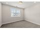 Minimalist bedroom with neutral tones and ample natural light from a large window at 656 Soul Aly # 101, Alpharetta, GA 30009