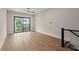 Bedroom boasts hardwood floors, neutral walls, a ceiling fan, and a sliding glass door at 656 Soul Aly # 101, Alpharetta, GA 30009