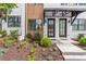 Inviting entrance of a townhome with manicured landscaping and modern exterior design at 656 Soul Aly # 101, Alpharetta, GA 30009