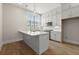 Bright white kitchen featuring a center island, stainless steel appliances, and pendant lighting at 656 Soul Aly # 101, Alpharetta, GA 30009