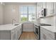Modern white kitchen with stainless appliances and large window above the sink at 656 Soul Aly # 101, Alpharetta, GA 30009