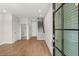 Inviting living room with hardwood floors, staircase, and bathroom access at 656 Soul Aly # 101, Alpharetta, GA 30009