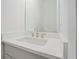 Elegant powder room features a white vanity, modern faucet, and a large mirror at 656 Soul Aly # 101, Alpharetta, GA 30009