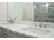 Stylish bathroom featuring double sinks, modern faucets, and a large mirror, and walk in shower at 656 Soul Aly # 101, Alpharetta, GA 30009