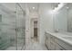 Luxurious bathroom with a glass-enclosed shower, double vanity, and modern fixtures at 656 Soul Aly # 101, Alpharetta, GA 30009