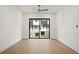 Bright bedroom with hardwood floors and a large sliding glass door providing ample light at 656 Soul Aly # 101, Alpharetta, GA 30009