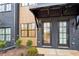 Inviting townhome entryway featuring a black brick facade and a stylish black awning at 656 Soul Aly # 101, Alpharetta, GA 30009