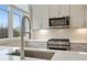 Modern kitchen features stainless steel appliances, sleek countertops, and a stylish backsplash at 656 Soul Aly # 101, Alpharetta, GA 30009