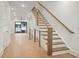 Modern staircase features wooden steps and a sleek railing leading to the upper level at 656 Soul Aly # 101, Alpharetta, GA 30009
