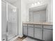 Updated bathroom with double vanity sinks, granite countertops, and a glass walk-in shower at 7678 Gray Pointe Dr, Lithonia, GA 30058
