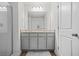 Bathroom features double vanity, grey cabinets, granite countertop, and walk-in glass shower at 7678 Gray Pointe Dr, Lithonia, GA 30058