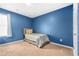 Blue accent wall bedroom with a window and neutral carpet at 7678 Gray Pointe Dr, Lithonia, GA 30058