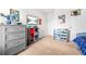 Bedroom featuring a dresser, mounted TV, storage, and decor at 7678 Gray Pointe Dr, Lithonia, GA 30058
