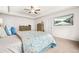 Bright bedroom featuring carpet flooring, a ceiling fan, and a mounted television at 7678 Gray Pointe Dr, Lithonia, GA 30058
