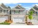 Charming townhome showcases a well-manicured lawn, a two-car garage, and beautiful landscaping at 7678 Gray Pointe Dr, Lithonia, GA 30058