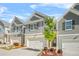 Beautiful townhome with a two-car garage, brick accents, and well-maintained landscaping at 7678 Gray Pointe Dr, Lithonia, GA 30058