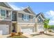 Beautiful townhome with a two-car garage, brick accents, and well-maintained landscaping at 7678 Gray Pointe Dr, Lithonia, GA 30058
