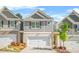 Charming townhome showcases a well-manicured lawn, a two-car garage, and beautiful landscaping at 7678 Gray Pointe Dr, Lithonia, GA 30058