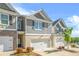 Beautiful townhome with a two-car garage, brick accents, and well-maintained landscaping at 7678 Gray Pointe Dr, Lithonia, GA 30058