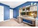 Home office with custom desk and shelving featuring an eye catching blue accent wall at 7678 Gray Pointe Dr, Lithonia, GA 30058