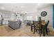 Open-concept living area with modern kitchen, dining table, comfortable living room furniture, and fireplace at 7678 Gray Pointe Dr, Lithonia, GA 30058