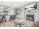 Bright living room with a fireplace, modern furniture, and an open view to the kitchen area at 7678 Gray Pointe Dr, Lithonia, GA 30058