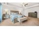 Bright main bedroom with a large bed, bench, and stylish nightstands with lamps at 7678 Gray Pointe Dr, Lithonia, GA 30058