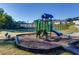 Community playground with slide, swing set, and climbing structure near the tennis court and residential buildings at 7678 Gray Pointe Dr, Lithonia, GA 30058