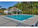 Community pool and pool house with lounge chairs, landscaping, and fencing at 7678 Gray Pointe Dr, Lithonia, GA 30058
