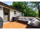 Relax on the wooden back deck featuring comfortable seating and string lights for a cozy outdoor experience at 2171 Plantation Ln, Chamblee, GA 30341