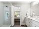 Elegant bathroom with double vanity, updated lighting, and glass walk-in shower at 2171 Plantation Ln, Chamblee, GA 30341
