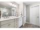 Elegant bathroom featuring double vanity, updated lighting, and walk-in glass shower at 2171 Plantation Ln, Chamblee, GA 30341