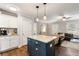 Open concept kitchen with a center island, stainless steel appliances, and seamless transition to the living area at 2171 Plantation Ln, Chamblee, GA 30341