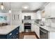 Updated kitchen with stainless appliances, granite countertops, white cabinets, and an island with bar seating at 2171 Plantation Ln, Chamblee, GA 30341