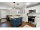 Kitchen featuring stainless steel appliances, granite countertops, kitchen island seating, and an open concept living area at 2171 Plantation Ln, Chamblee, GA 30341