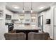 Modern kitchen with white cabinets, stainless steel appliances, granite countertops and a navy island with bar stool seating at 2171 Plantation Ln, Chamblee, GA 30341