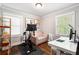 Home office featuring a desk, chair, exercise equipment, and natural light at 2171 Plantation Ln, Chamblee, GA 30341