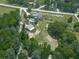 Overhead view of property with lush green lawn, fenced yard, swimming pool, detached garage and mature trees at 2347 Univeter Rd, Canton, GA 30115