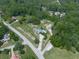 Stunning aerial view of a well-maintained home, expansive lawn, and a refreshing pool nestled in a lush, wooded landscape at 2347 Univeter Rd, Canton, GA 30115