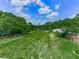 Expansive backyard with lush green grass and mature trees provides a private outdoor space at 2347 Univeter Rd, Canton, GA 30115