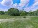 Expansive backyard with lush green grass and mature trees provides a private outdoor space at 2347 Univeter Rd, Canton, GA 30115
