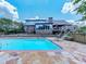 The backyard boasts a sparkling pool, stone patio, wooden deck, and mature trees for ultimate relaxation and enjoyment at 2347 Univeter Rd, Canton, GA 30115