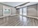 Basement featuring light gray walls, wood-look floors, and double doors to outside at 2347 Univeter Rd, Canton, GA 30115