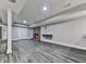 Spacious basement featuring gray vinyl plank flooring, brick fireplace and recessed lighting at 2347 Univeter Rd, Canton, GA 30115